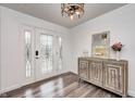 Bright entryway with a rustic console table, wood-look floors, and a glass door at 5909 Buttonwood Dr, Noblesville, IN 46062