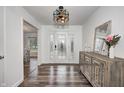 Light and airy entryway with console table, wood-look floors and glass door at 5909 Buttonwood Dr, Noblesville, IN 46062