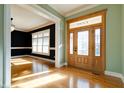 Spacious entryway with hardwood floors, a view of the dining room, and access to other rooms at 7290 Lockford Walk N, Avon, IN 46123