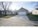 House exterior showcasing a white garage door and landscaping at 8391 Inland Dr, Avon, IN 46123
