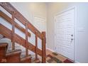 Wooden staircase with carpet runner and access to upper levels at 1127 Grant Cir, Cicero, IN 46034