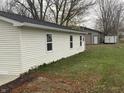 White vinyl sided home with new gutters and landscaping at 706 W Franklin St, Thorntown, IN 46071