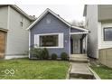 Charming blue bungalow with a well-maintained lawn and walkway at 907 S East St, Indianapolis, IN 46225