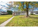 Charming ranch home nestled amongst mature trees and a well-manicured lawn at 2666 Lafayette Ave, Columbus, IN 47201