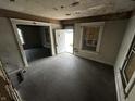 Empty living room with exposed walls and floors, ready for renovation at 1210 N Rural St, Indianapolis, IN 46201