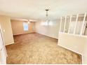 Large living room with carpet and chandelier at 1632 Wellesley Ct # 6, Indianapolis, IN 46219