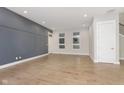 Spacious living room with hardwood floors and gray accent wall at 1213 Cottage Ave, Indianapolis, IN 46203