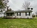 Ranch style home with a covered porch and satellite dish at 3149 E 900 S, Flat Rock, IN 47234