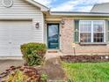 Green front door and brick facade at 5397 Dollar Forge Ct, Indianapolis, IN 46221