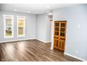 Spacious living room with hardwood floors and large windows at 700 S Ohio St, Sheridan, IN 46069