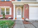 Inviting front entrance with a brick facade and pumpkins at 11411 Shady Hollow Ln, Indianapolis, IN 46229