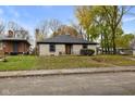Brick ranch house with a landscaped lawn at 3805 Byram Ave, Indianapolis, IN 46208