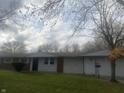 Ranch home with brick and siding exterior, and a spacious lawn at 3936 Delmont Dr, Indianapolis, IN 46235