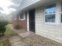 Front entrance with brick and stone facade, and a security door at 3936 Delmont Dr, Indianapolis, IN 46235