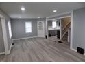 Spacious living room featuring gray walls, vinyl wood flooring, and an open concept floor plan at 4016 N Tacoma Ave, Indianapolis, IN 46205