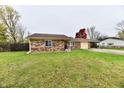 Brick ranch house with a large yard and mature trees at 7922 S Sherman Dr, Indianapolis, IN 46237