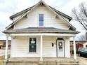 White sided home with front porch and mature trees at 310 S Pleasant St, Edinburgh, IN 46124