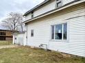 White sided home with a detached garage and a well-maintained lawn at 310 S Pleasant St, Edinburgh, IN 46124