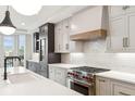 Modern kitchen with white and dark cabinets, quartz countertops and a gas range at 41 N Rangeline Rd # 7, Carmel, IN 46032