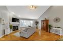 Living room with hardwood floors, fireplace, and large window at 7093 Republic Ln, Indianapolis, IN 46259