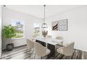 Bright dining room featuring a marble table, six chairs, and wood-look floors at 1782 N Clearwater Dr, Greenfield, IN 46140
