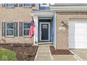 Welcoming front entrance with a black door, brick accents, and a walkway at 1782 N Clearwater Dr, Greenfield, IN 46140