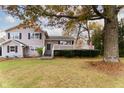 Two-story house with gray siding, deck, and mature trees in the front yard at 2355 W State Road 234, Fortville, IN 46040
