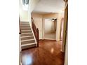 Hardwood floors, staircase, and access to other rooms at 4835 Franklin Villas Dr, Indianapolis, IN 46237