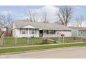 White ranch house with a carport and a fenced yard at 8530 Meadowlark Dr, Indianapolis, IN 46226