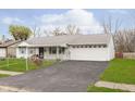Front view of a ranch home with a long driveway at 8530 Meadowlark Dr, Indianapolis, IN 46226