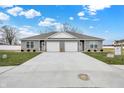 New gray duplex with a two-car garage and well-maintained lawn at 1501 Coen Ct, Columbus, IN 47201
