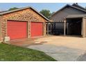Two-car garage with red doors and additional covered parking at 306 E Cherry St, Advance, IN 46102