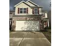 Two-story house with tan siding, brick bottom, and a two-car garage at 3518 Birchfield Pl, Indianapolis, IN 46268