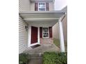 Inviting front porch with a red door and brick accents at 3518 Birchfield Pl, Indianapolis, IN 46268