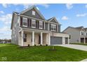 Two-story house with gray siding, brick accents, and a three-car garage at 4973 Amber Crest Dr, Brownsburg, IN 46112