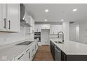 Modern kitchen with white cabinets, granite countertops, and a large island at 4973 Amber Crest Dr, Brownsburg, IN 46112