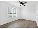Bright bedroom with wood-look floors and ceiling fan at 1482 Coen Ct, Columbus, IN 47201