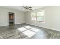 Simple bedroom with gray vinyl plank flooring and large window at 408 N Sherwood Dr, Muncie, IN 47304
