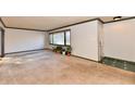 Spacious living room with large windows and neutral carpeting at 3620 Pinecrest Rd, Indianapolis, IN 46234