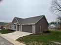 Side view of the house, showcasing the garage and stone accents at 4204 W Palomino Ct, Muncie, IN 47304