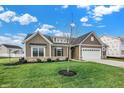 Attractive home with gray siding, stone accents, and a neatly manicured lawn at 7098 Sterling Way, Brownsburg, IN 46112