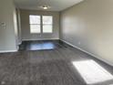 Spacious living room with gray carpeting and vinyl plank flooring at 7530 Redcliff Rd, Indianapolis, IN 46256