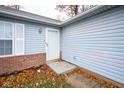 White front door entry with brick base and gray siding at 3440 Cherry Lake Rd, Indianapolis, IN 46235