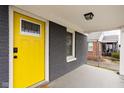 Yellow front door with glass accents and black hardware at 5114 Hillside Ave, Indianapolis, IN 46205