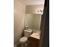 Simple bathroom with single vanity, toilet, and large mirror at 636 Creston Point Cir, Indianapolis, IN 46239