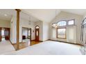 Two-story entryway with hardwood floors and an open floor plan at 9699 Prairiewood Way, Carmel, IN 46032
