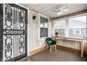 Enclosed porch with wood walls and wrought iron door at 1708 S Randolph St, Indianapolis, IN 46203
