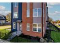 Front view of a modern townhome with brick and blue siding at 2151 N College Ave, Indianapolis, IN 46202