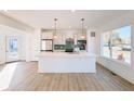 Modern kitchen with white cabinets, quartz countertops, and stainless steel appliances at 2151 N College Ave, Indianapolis, IN 46202