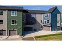 Rear view of townhomes showcasing garages and private patios at 2151 N College Ave, Indianapolis, IN 46202